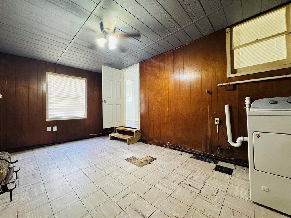 4393 Old Dallas Road Elm Mott, TX 76640 - Photo 14 of 19 Laundry room with washer / dryer, ceiling fan, and wood walls