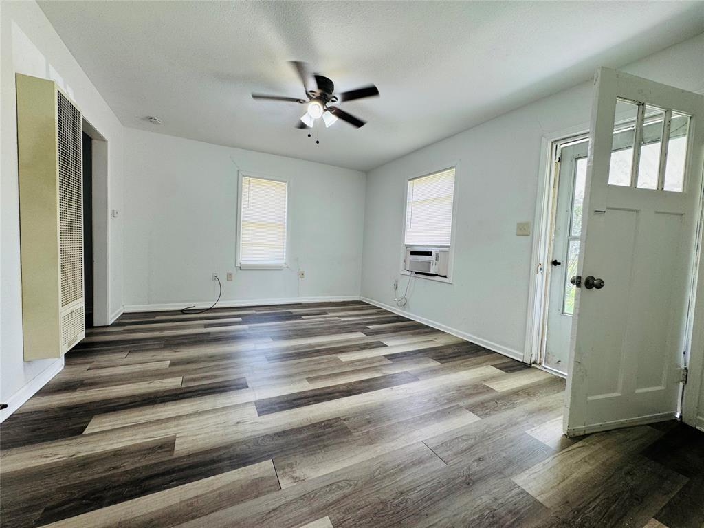 4393 Old Dallas Road Elm Mott, TX 76640 - Photo 2 of 19 Foyer entrance featuring ceiling fan, plenty of natural light, wood finished floors, and a heating unit