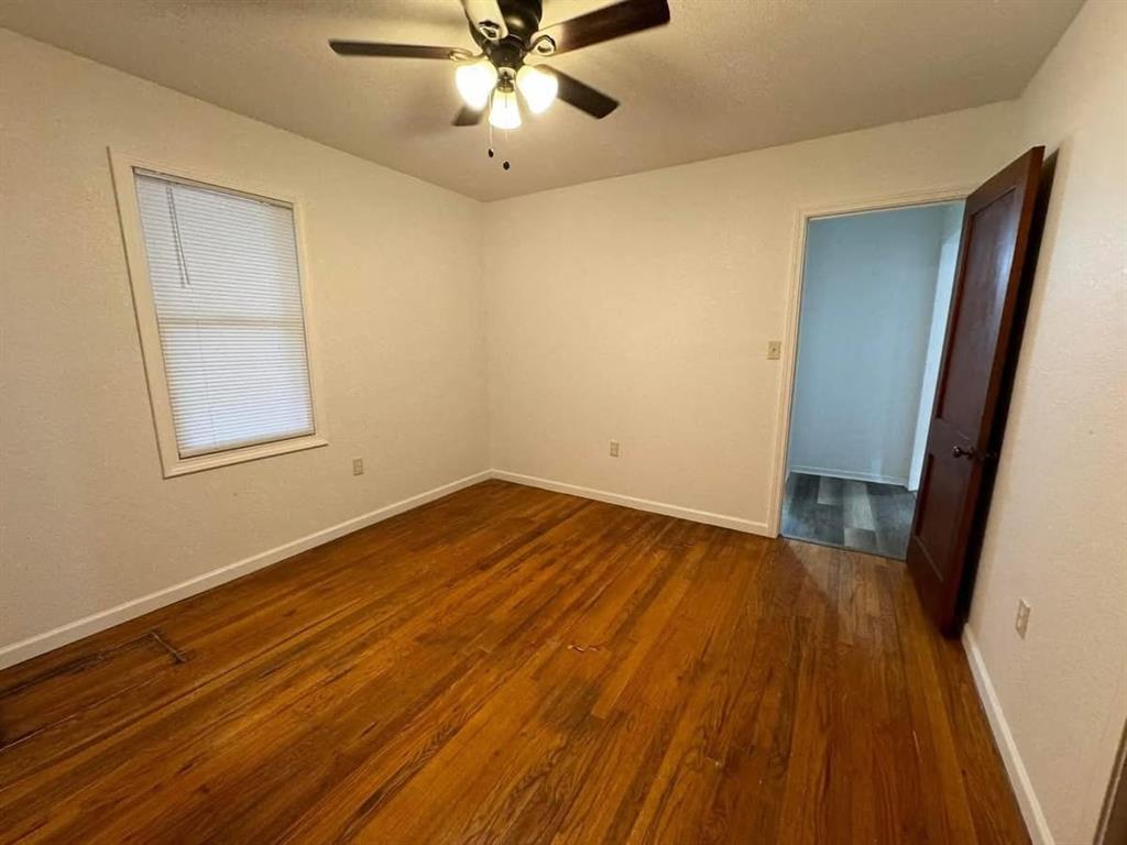 4393 Old Dallas Road Elm Mott, TX 76640 - Photo 5 of 19 Unfurnished room with wood finished floors and ceiling fan