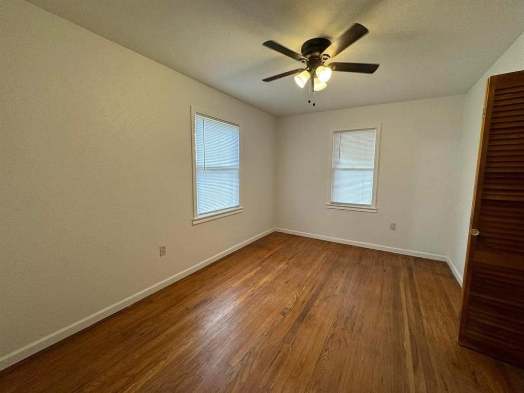 4393 Old Dallas Road Elm Mott, TX 76640 - Photo 6 of 19 Spare room featuring wood finished floors and a ceiling fan