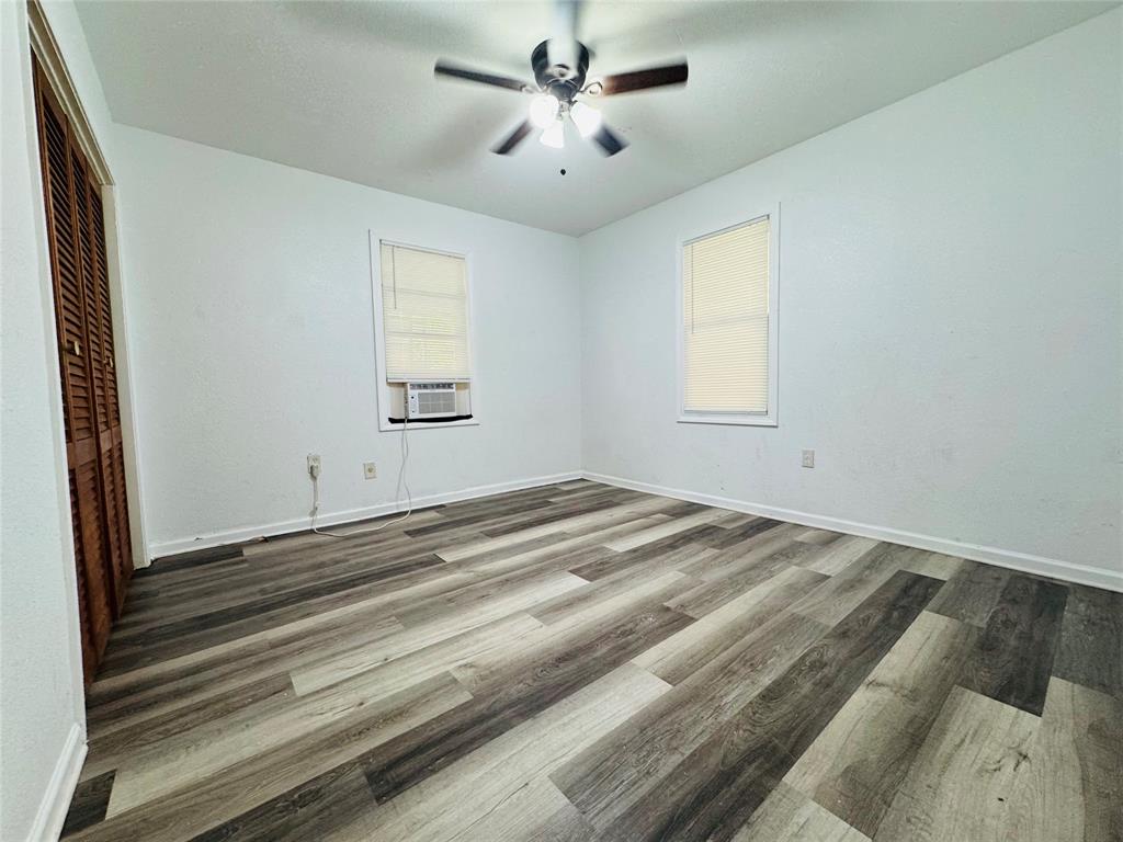 4393 Old Dallas Road Elm Mott, TX 76640 - Photo 7 of 19 Unfurnished bedroom with wood finished floors, cooling unit, a closet, and ceiling fan