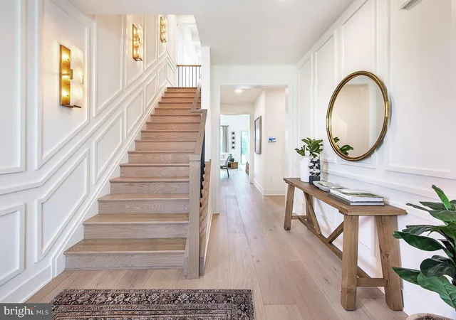 a view of a hallway with wooden floor and entryway