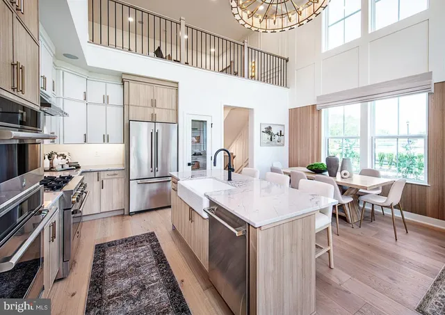 a kitchen with stainless steel appliances granite countertop a stove a sink dishwasher and a refrigerator