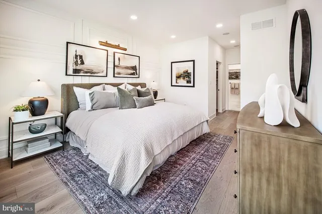 a bedroom with bed and wooden floor