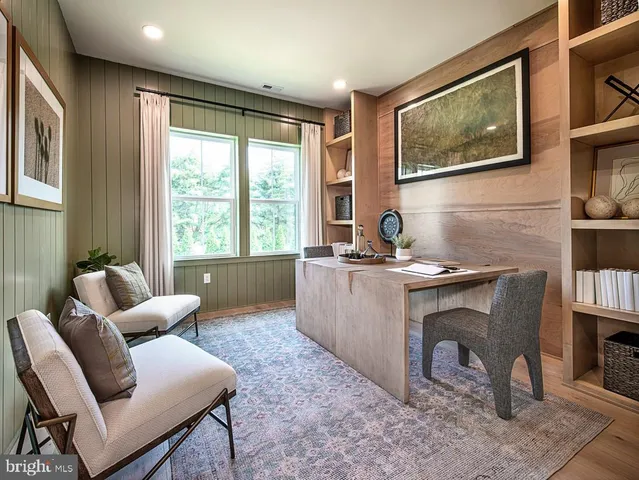 a living room with furniture a window and a flat screen tv