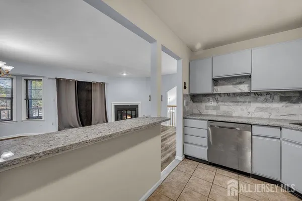 a kitchen with stainless steel appliances granite countertop a sink and cabinets