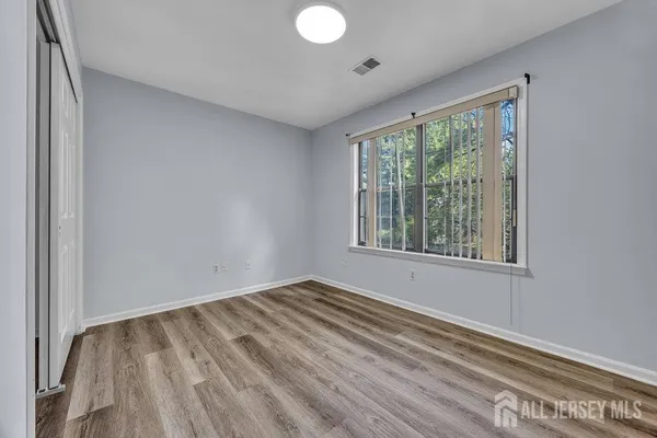 a view of room with window and hardwood floor