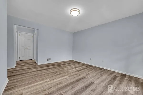 a view of an empty room and wooden floor
