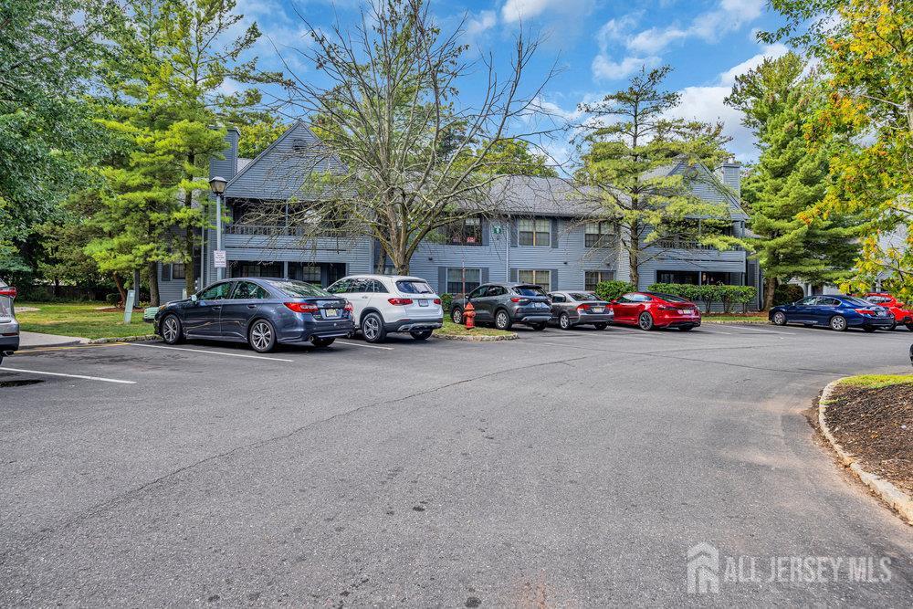 604 Woodhaven Drive Edison, NJ 08817 - Photo 30 of 38 a view of road with card parked on side and retail shops