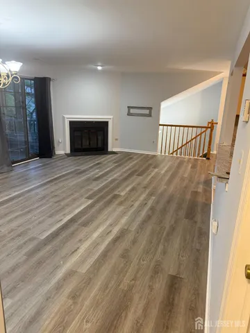 a view of a room with wooden floor and stairs