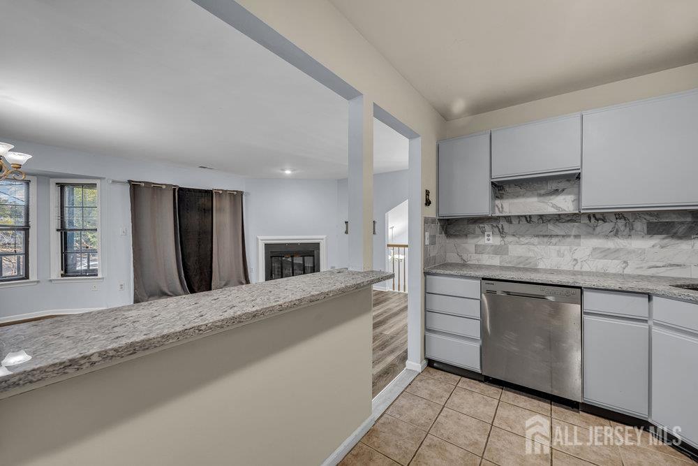604 Woodhaven Drive Edison, NJ 08817 - Photo 36 of 38 a kitchen with stainless steel appliances granite countertop a sink and cabinets