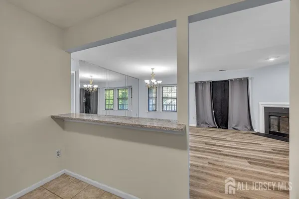 a view of an empty room with a fireplace and a window