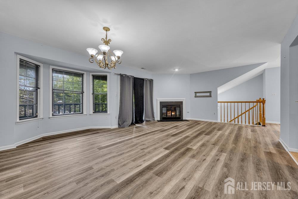 604 Woodhaven Drive Edison, NJ 08817 - Photo 6 of 38 a view of an empty room with wooden floor and a window