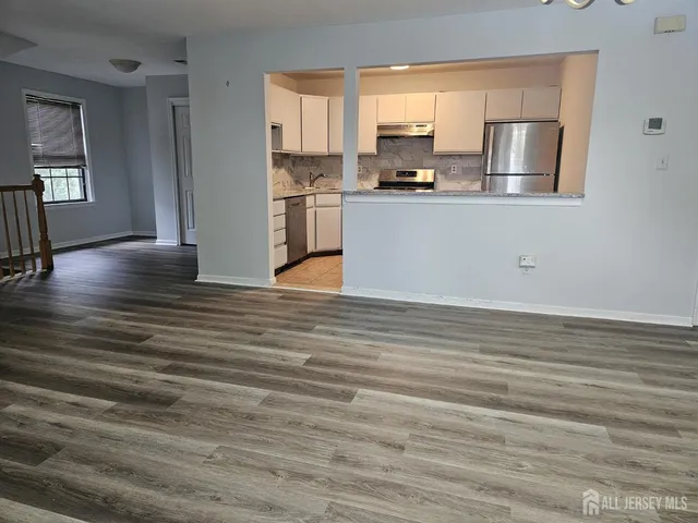 a kitchen with stainless steel appliances granite countertop a refrigerator a stove top oven a sink with granite countertops and cabinets