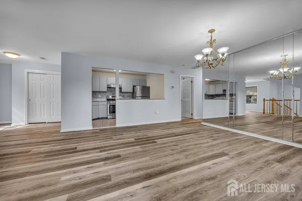 a view of a kitchen with a sink and chandelier