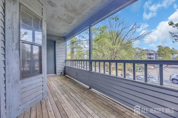 a view of a balcony with wooden floor