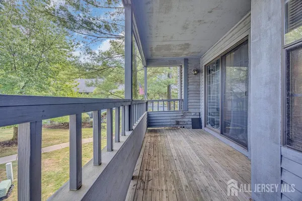 a view of a porch with wooden floor and outdoor space