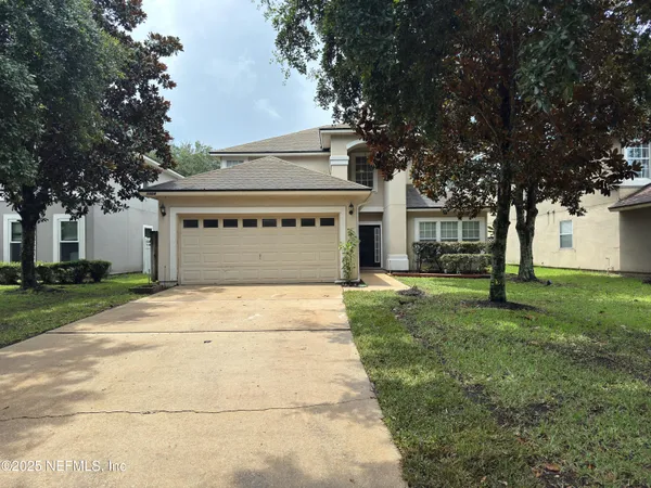 a front view of a house with a yard