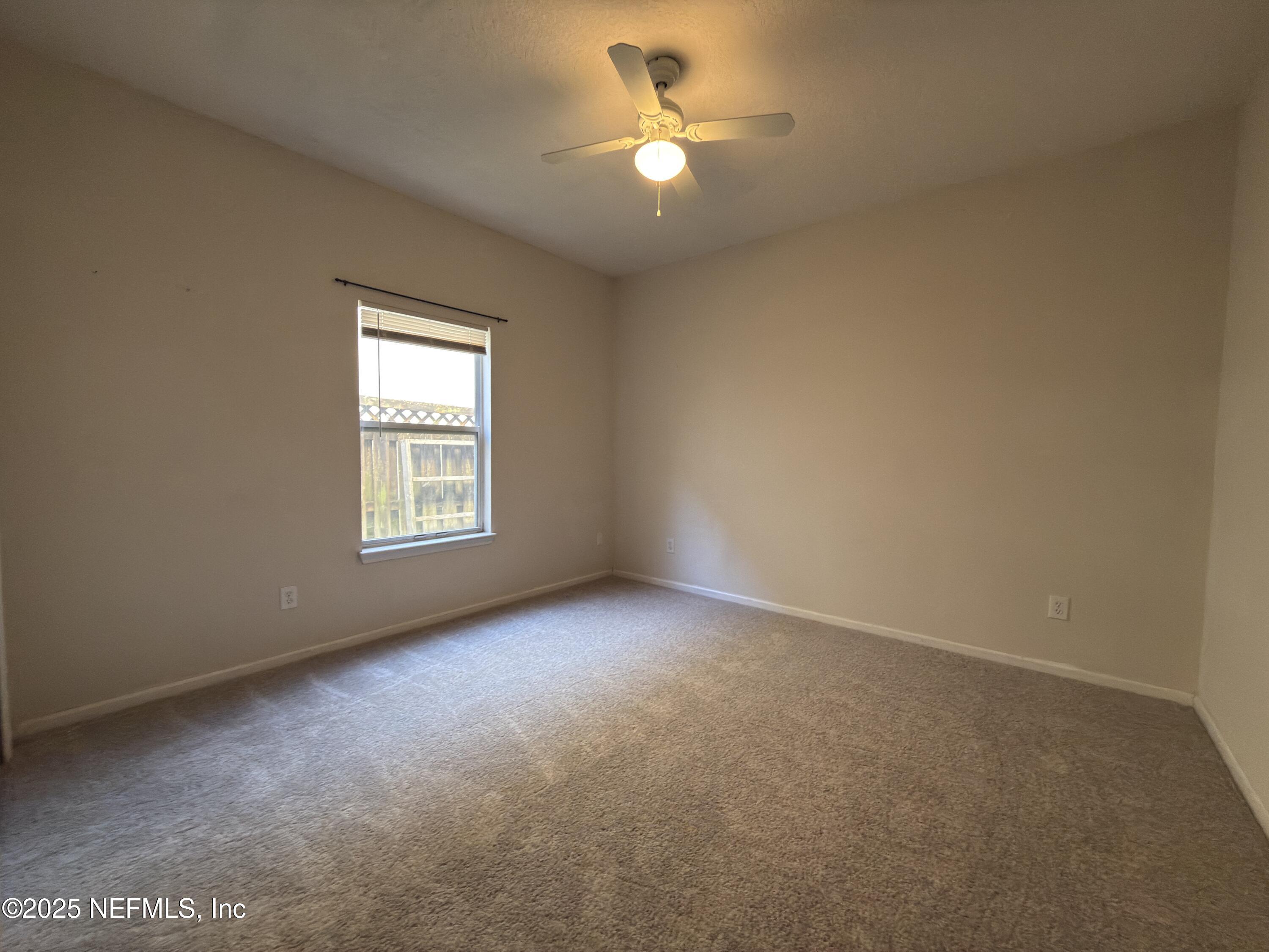 1324 Wekiva Way St. Augustine, FL 32092 - Photo 25 of 42 an empty room with a window and a ceiling fan