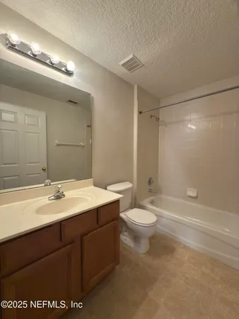 a bathroom with a double vanity sink toilet and shower