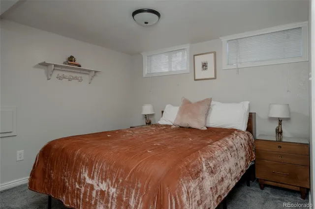 a large bed sitting in a bedroom next to a lamp