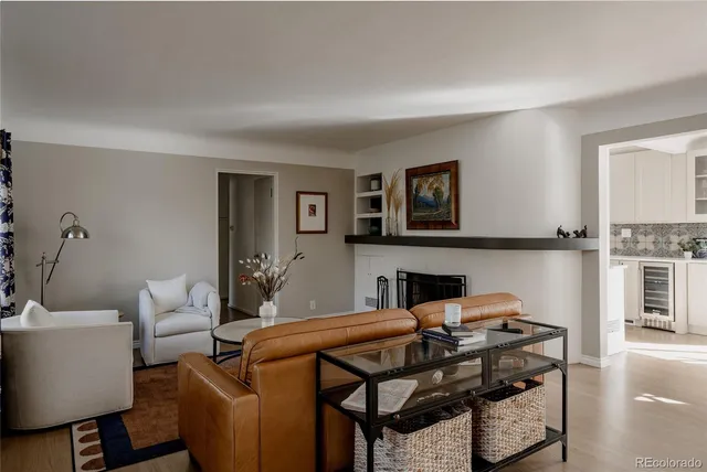 a living room with furniture a rug and a fireplace