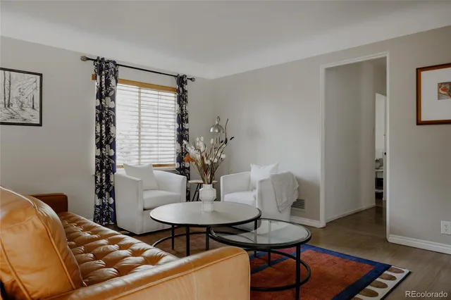 a living room with furniture and a potted plant