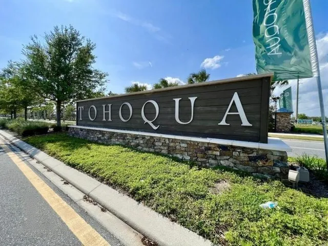 a street sign that is on a wooden wall