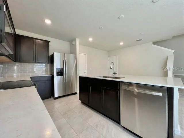 a kitchen with a sink and refrigerator