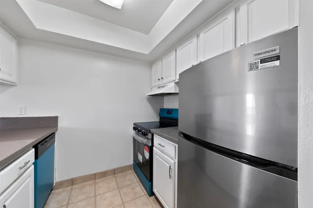 a kitchen with a refrigerator and a stove