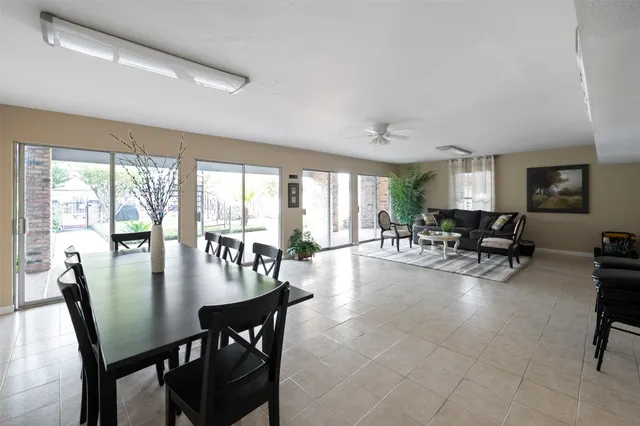a view of a dining room with furniture and a large window