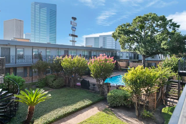 a view of a backyard with plants and a patio