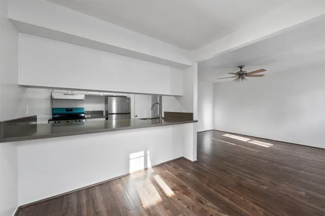 a living room with hard wood floors and a fireplace