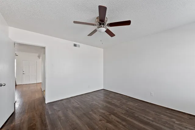 a view of a room with wooden floor and white walls