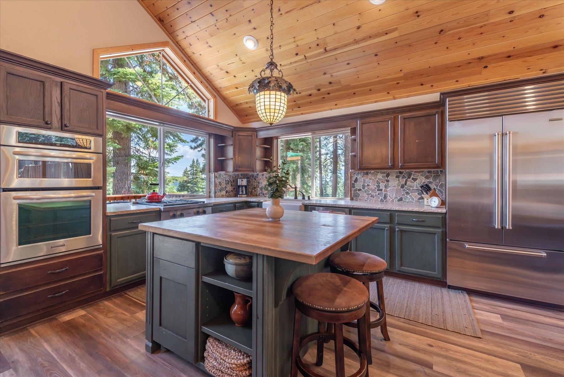 14265 Hansel Avenue Truckee, CA 96161 - Photo 6 of 21 a kitchen with stainless steel appliances granite countertop a sink a microwave cabinets and wooden floor