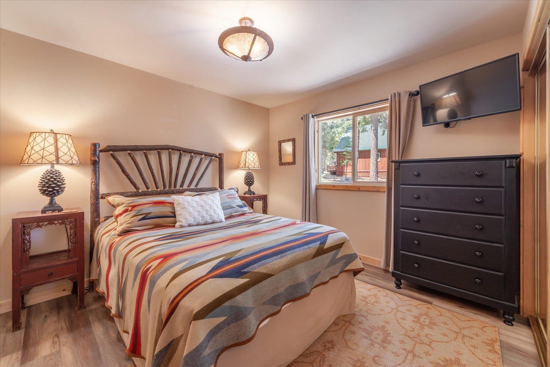 14265 Hansel Avenue Truckee, CA 96161 - Photo 10 of 21 a bedroom with a bed and a flat screen tv