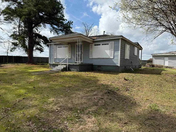 a view of a field with trees in the background