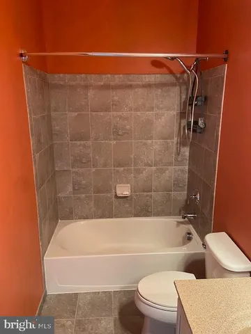 a bathroom with a toilet bathtub and shower