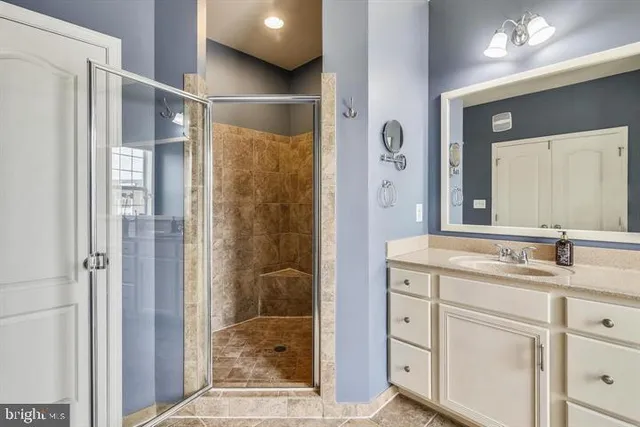 a bathroom with a shower sink and mirror