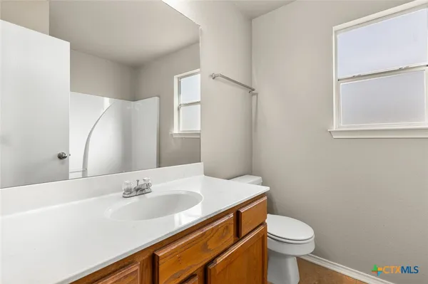 a bathroom with a sink toilet and vanity