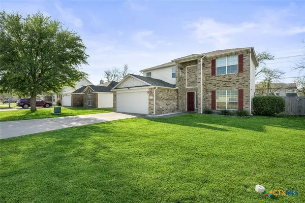 a front view of house with yard and green space