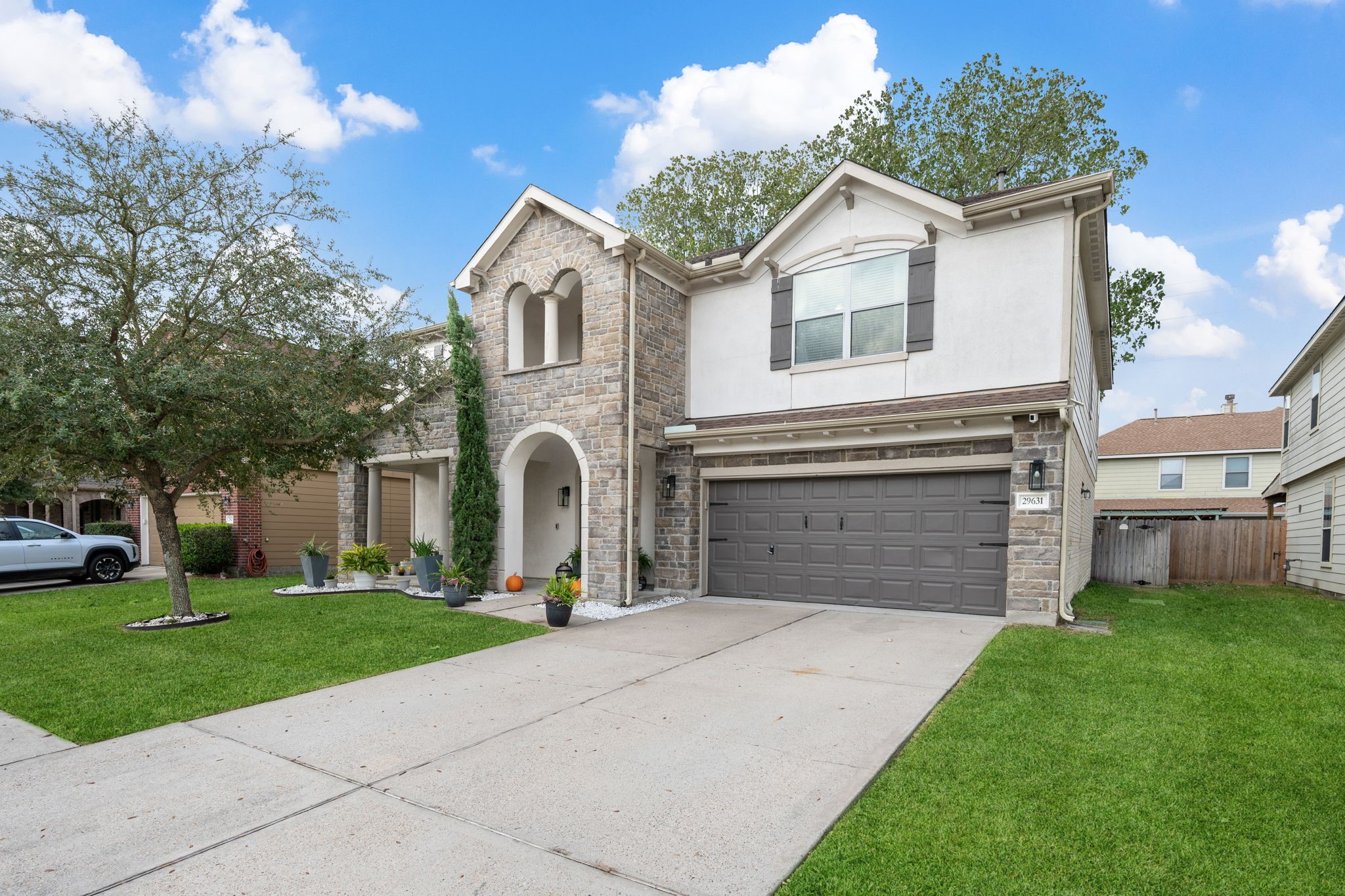a front view of a house with a yard and garage
