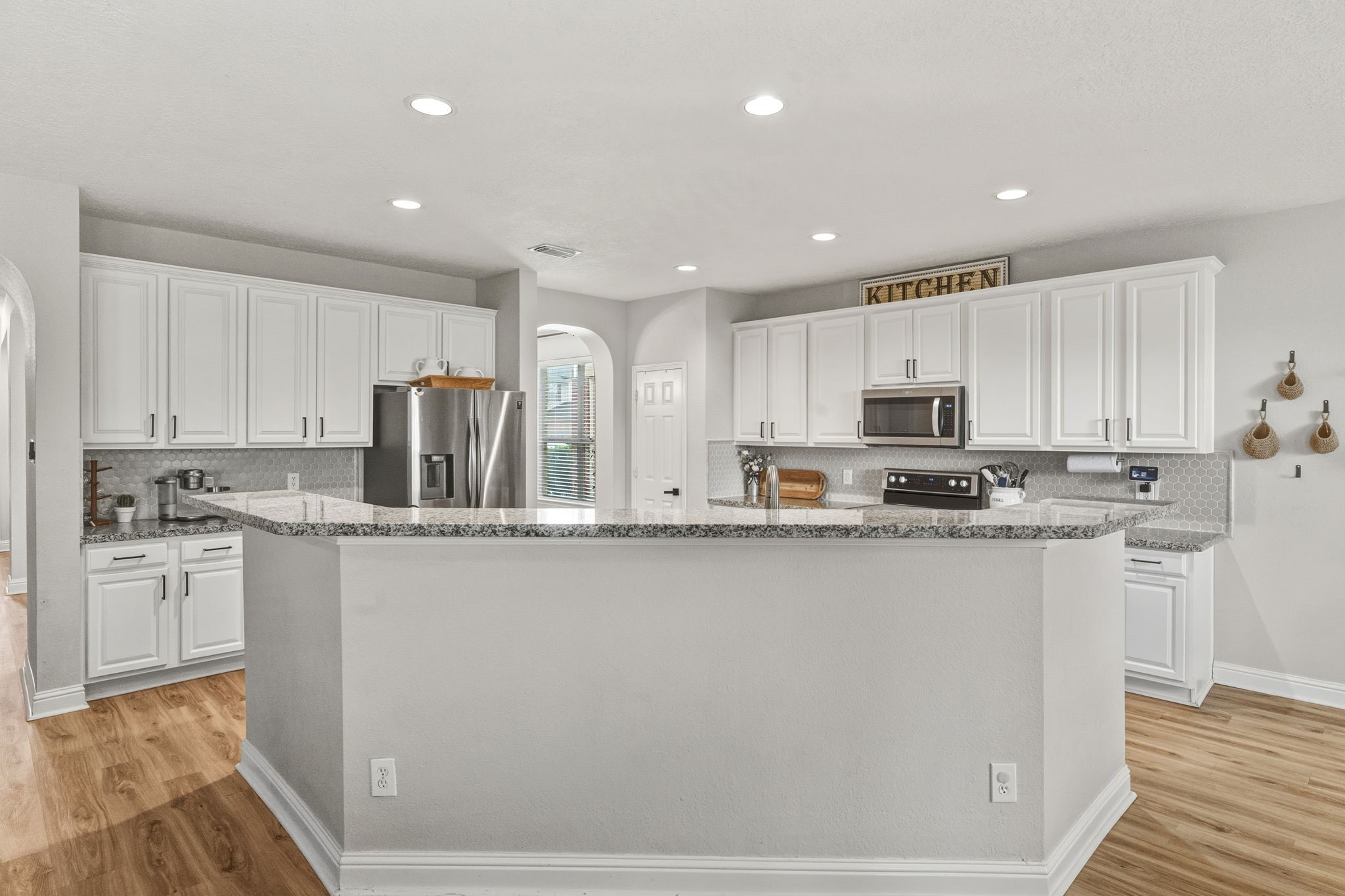 29631 Legends Line Drive Spring, TX 77386 - Photo 12 of 35 a kitchen with stainless steel appliances granite countertop a stove a sink and a refrigerator