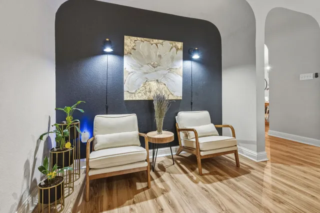 a view of a workspace with furniture and a window