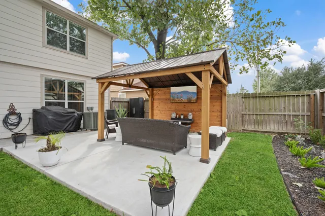 a view of a patio with table and chairs and potted plants