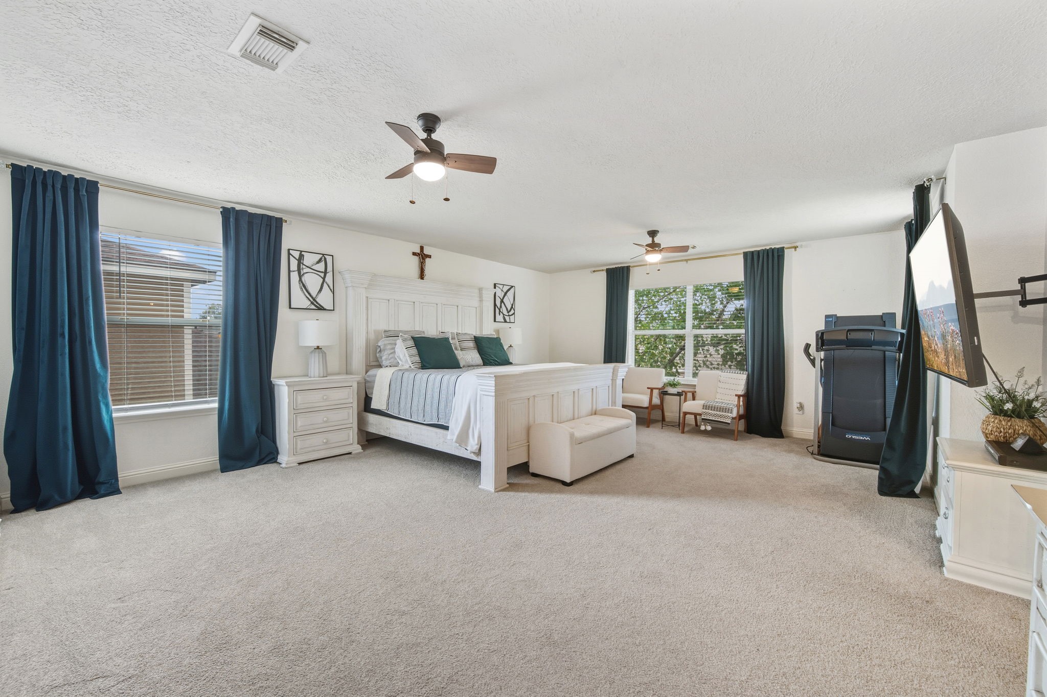 29631 Legends Line Drive Spring, TX 77386 - Photo 22 of 35 a spacious bedroom with a large bed and a chandelier