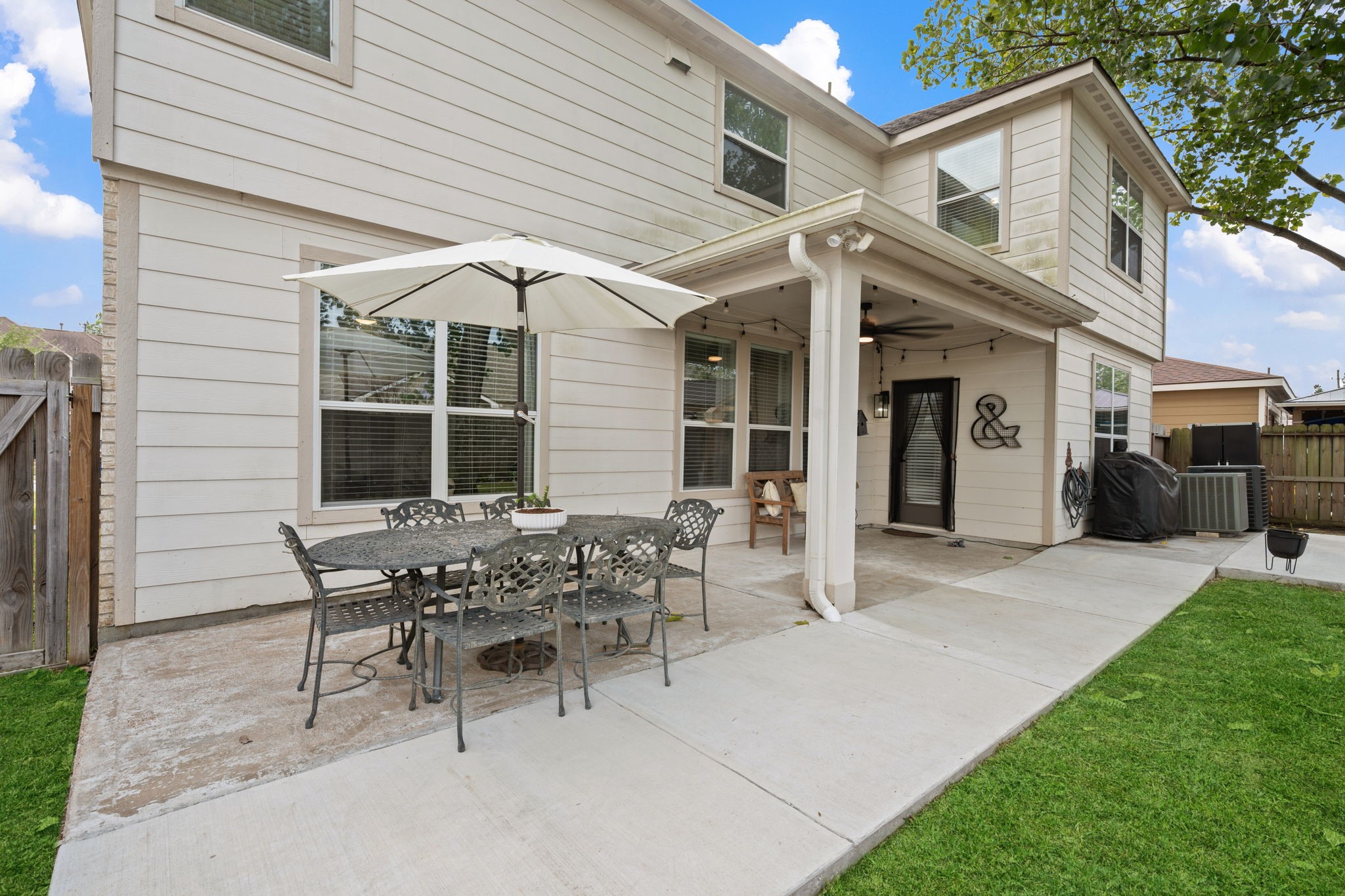 29631 Legends Line Drive Spring, TX 77386 - Photo 32 of 35 a view of a patio with table and chairs and a barbeque