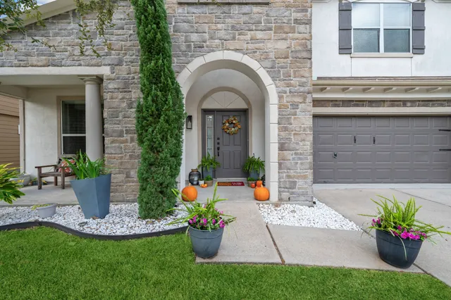 a view of a house with potted plants