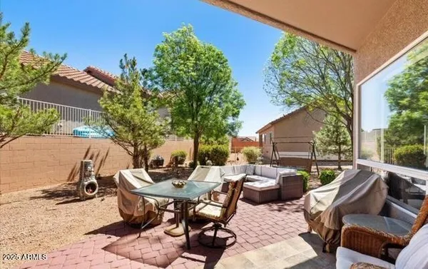 a view of a patio with table and chairs and potted plants