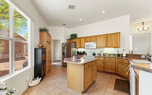 a kitchen with a sink stove and refrigerator